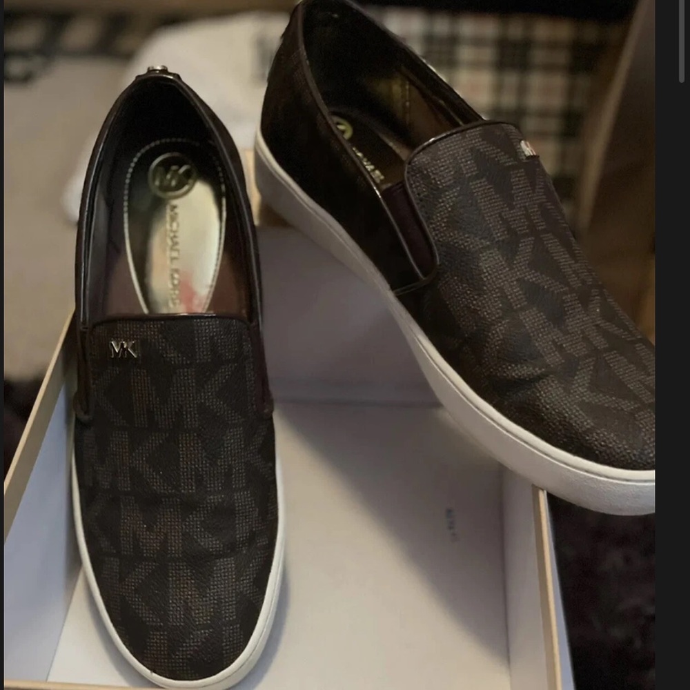 Michael Kors women’s Brown & Tan monogram Slip-On sneakers.